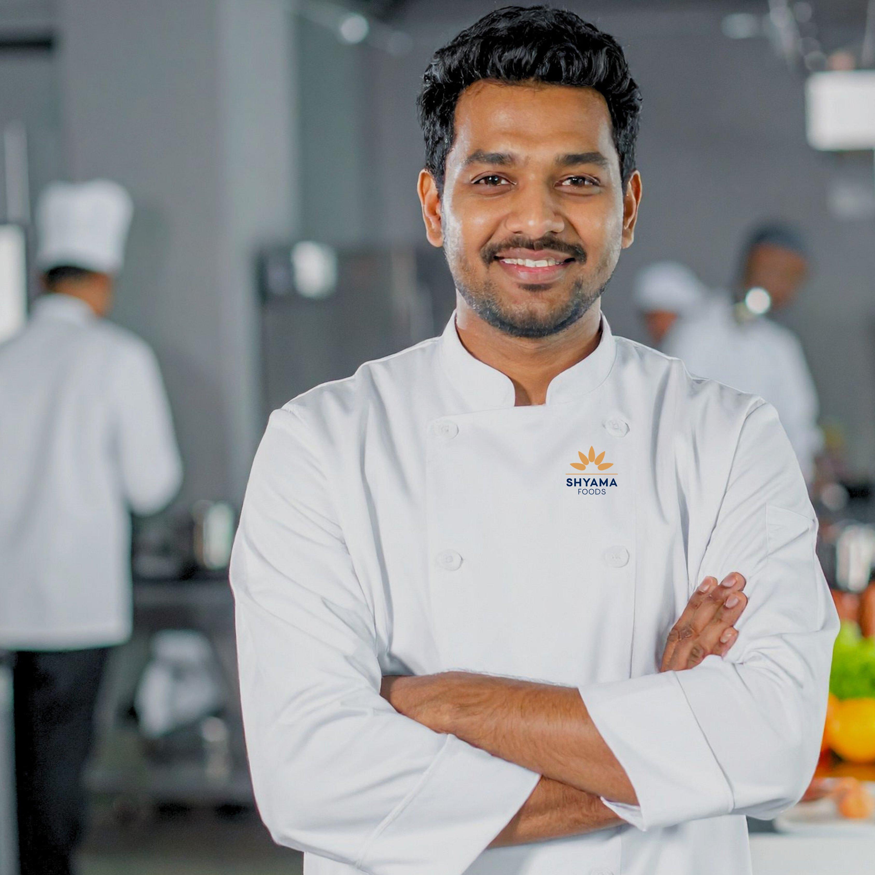 A Shyama Foods chef standing confidently in the kitchen