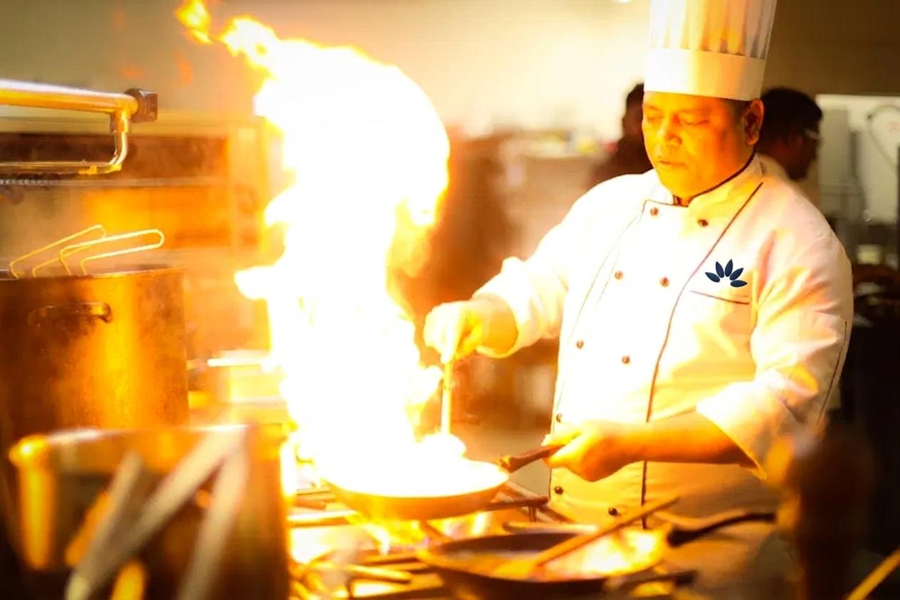 A Shyama Foods chef in uniform, with the Shyama Foods mark on the coat